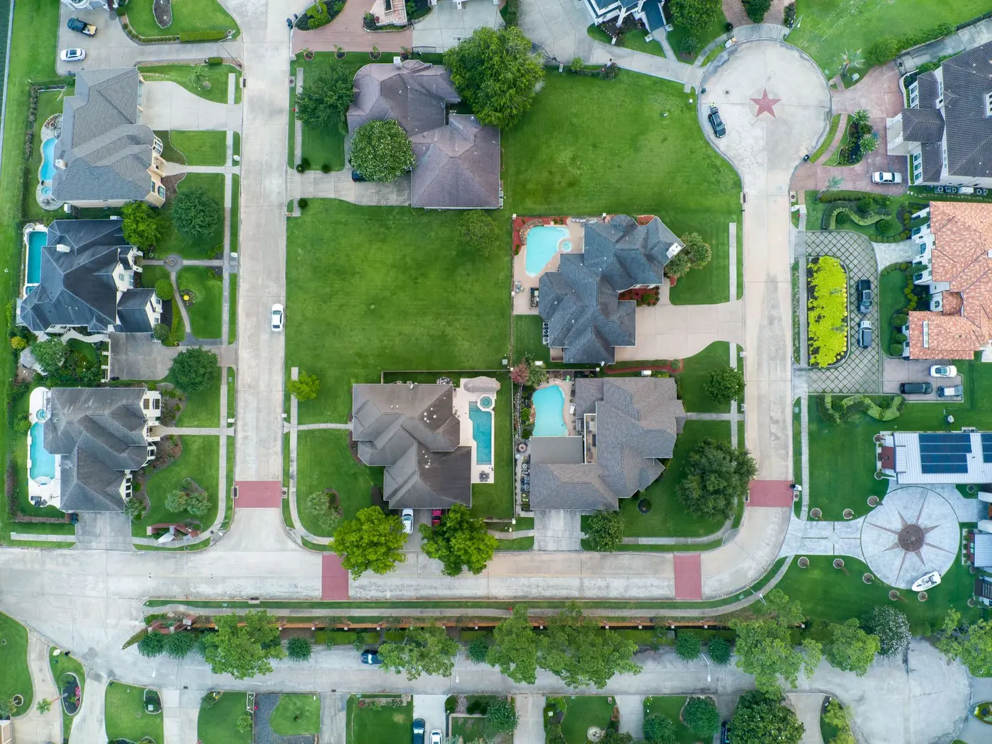 An aerial view of a suburban neighbourhood outside Houston, hundreds of pitched roofs laid out street by street